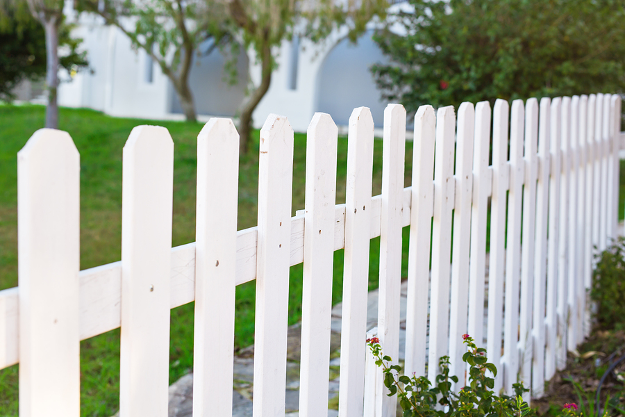 county style wooden fence. white fence and green grass