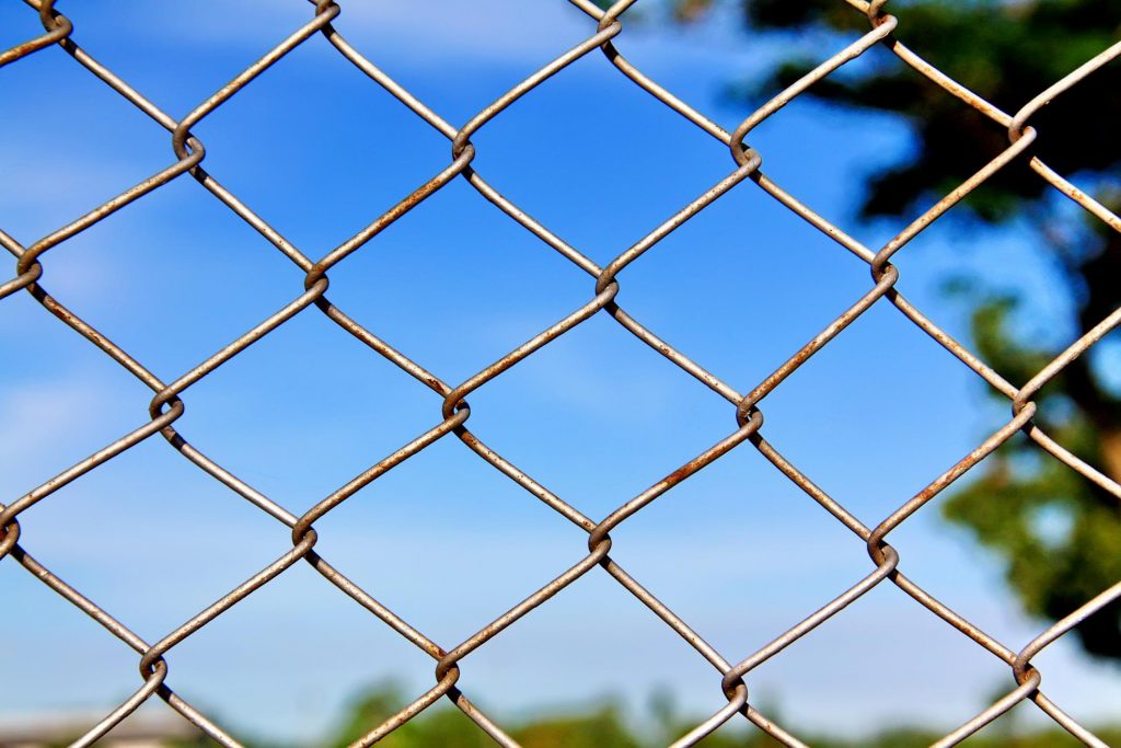 a rusty chain link fence